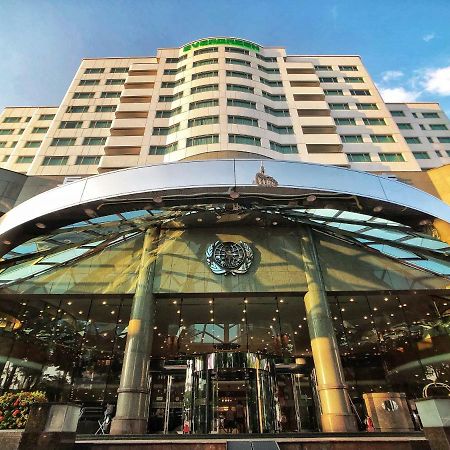 Evergreen Laurel Hotel - Taichung Extérieur photo The photo shows the exterior of a modern hotel building. The entrance features a large, glass canopy supported by columns, creating a welcoming area. The facade of the hotel is composed of a mix of glass and concrete, with large windows that suggest 